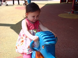 A child plays on a rocking elephant